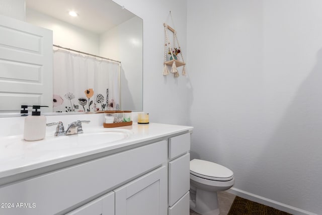 bathroom with vanity, toilet, and curtained shower