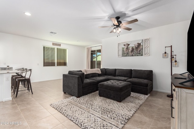 living room with ceiling fan and light tile patterned floors