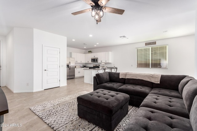 tiled living room with ceiling fan