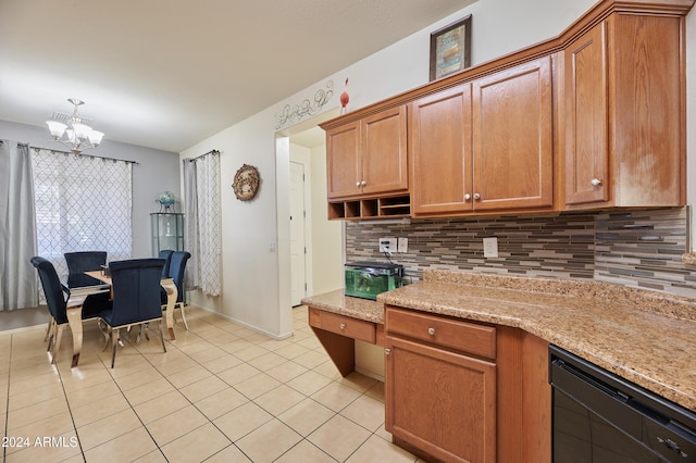 kitchen with tasteful backsplash, light stone counters, a notable chandelier, and black dishwasher