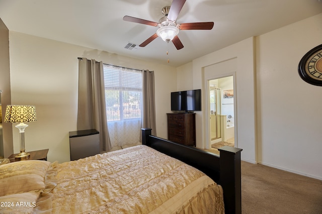 carpeted bedroom featuring ceiling fan and ensuite bathroom