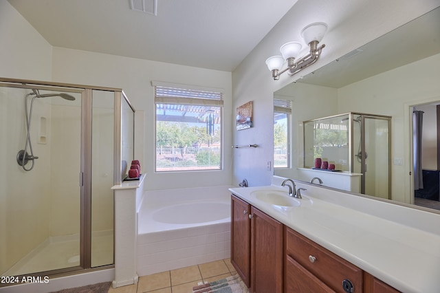 bathroom featuring tile patterned flooring, vanity, and separate shower and tub