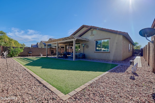 back of house with a yard, a patio, and ceiling fan