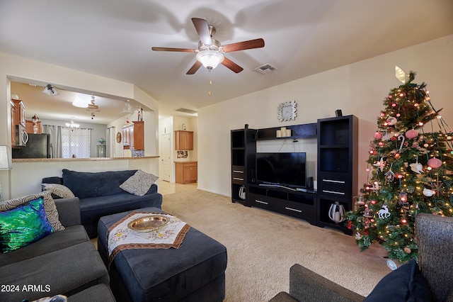 carpeted living room with ceiling fan