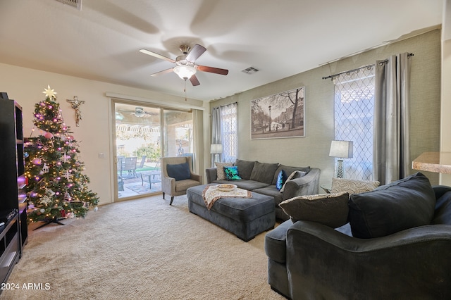 living room featuring light carpet and ceiling fan