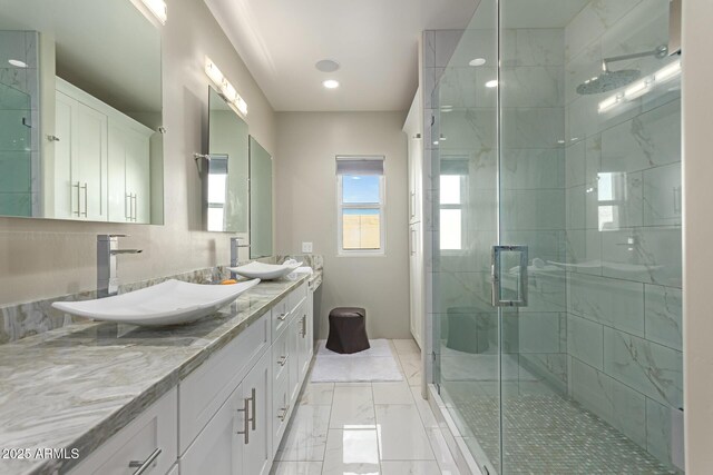 14749 E Pecos Rd, Gilbert, AZ 85295 - bathroom with double vanity, a sink, marble finish floor, and a stall shower