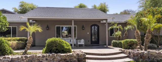 14749 E Pecos Rd, Gilbert, AZ 85295 - view of front of property with a porch, roof with shingles, and stucco siding