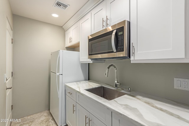 14749 E Pecos Rd, Gilbert, AZ 85295 - kitchen featuring a sink, white cabinets, stainless steel microwave, and visible vents