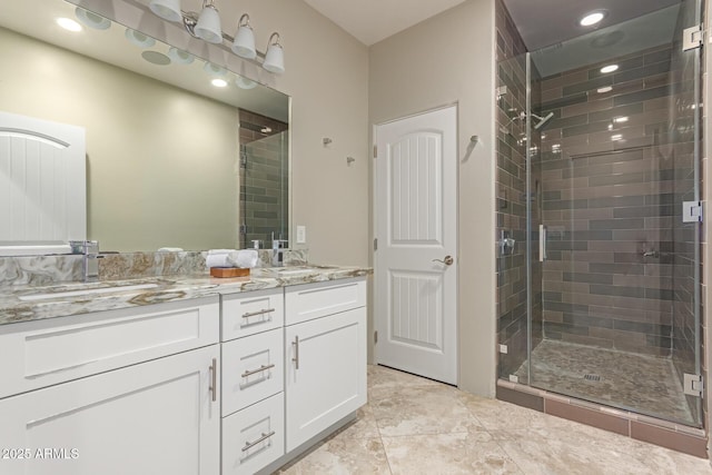 14749 E Pecos Rd, Gilbert, AZ 85295 - bathroom with a sink, a shower stall, recessed lighting, and double vanity
