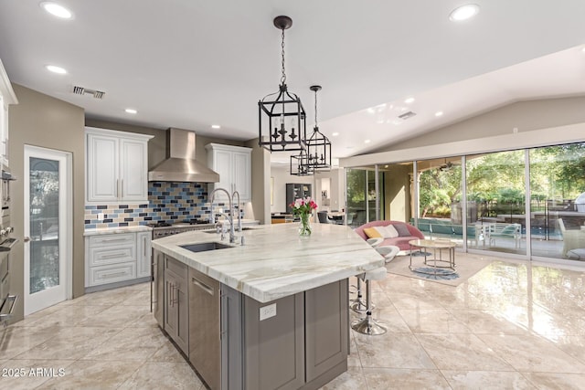 14749 E Pecos Rd, Gilbert, AZ 85295 - kitchen with recessed lighting, wall chimney exhaust hood, white cabinetry, a sink, and vaulted ceiling