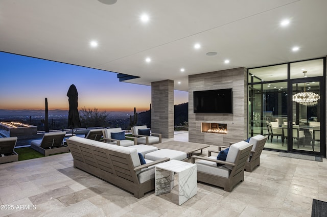 view of patio / terrace with an outdoor living space with a fireplace