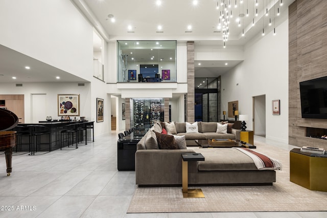 living room featuring light tile patterned flooring and a high ceiling