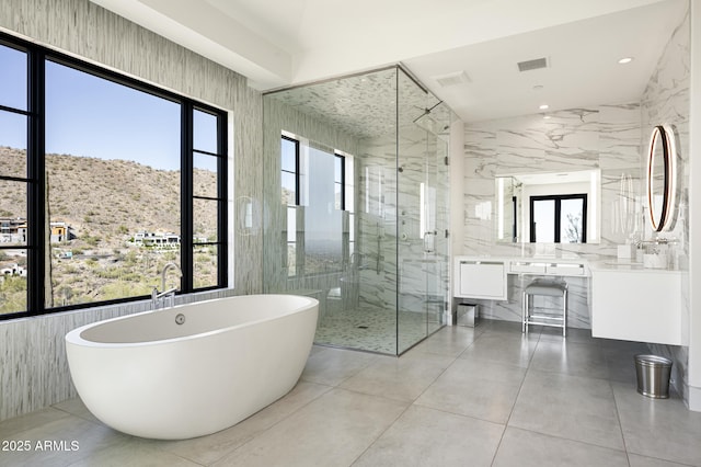 bathroom featuring vanity, a mountain view, and plus walk in shower