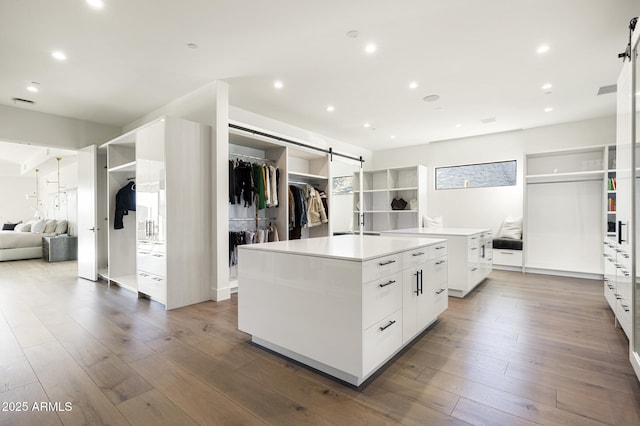 kitchen featuring white cabinetry, a kitchen island, and hardwood / wood-style flooring