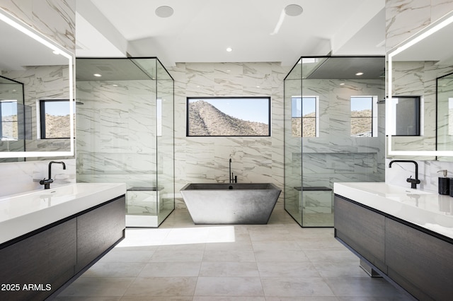 bathroom with vanity, independent shower and bath, and tile walls