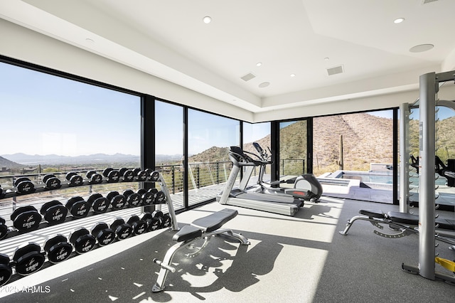 gym with plenty of natural light and a mountain view