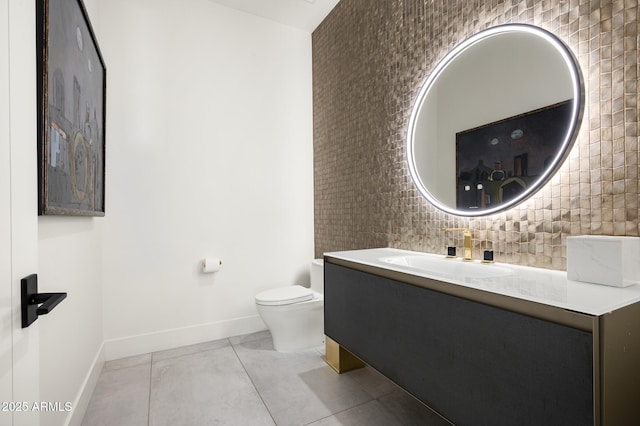 bathroom with vanity, decorative backsplash, tile patterned floors, and toilet