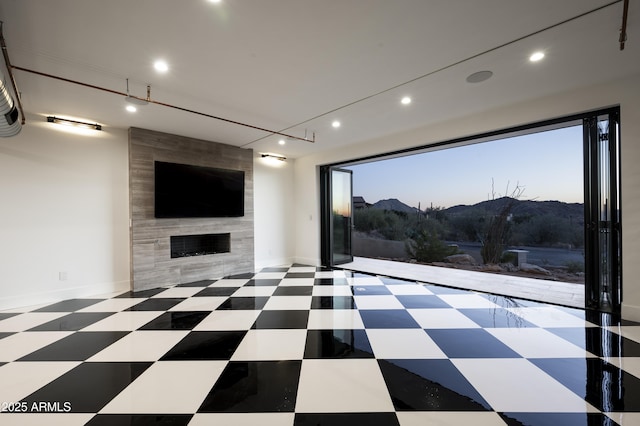 interior space with a tiled fireplace and plenty of natural light