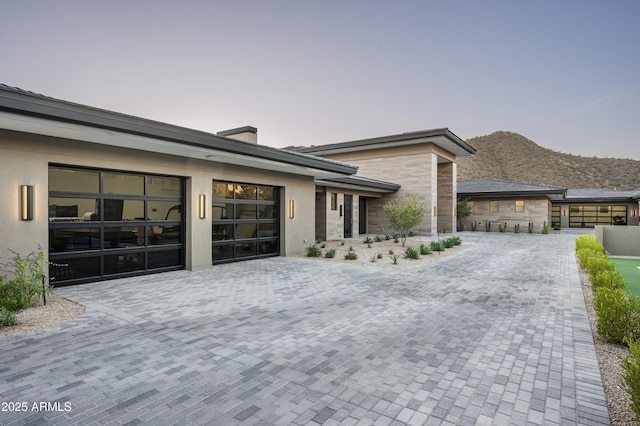 view of front of home with a garage and a mountain view