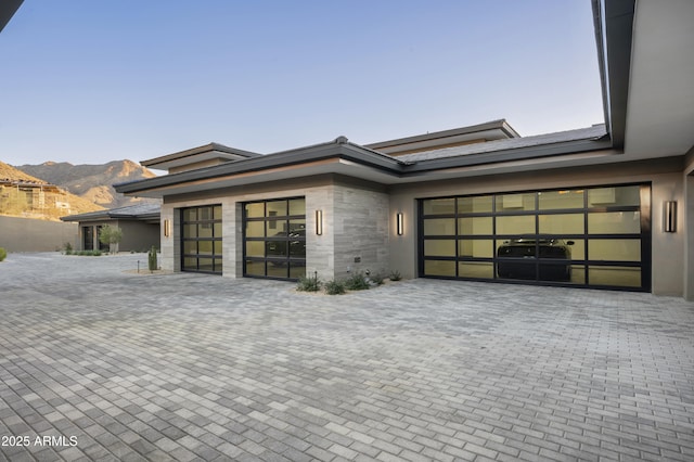 view of front of house featuring a garage and a mountain view