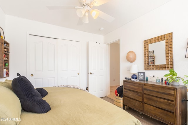 bedroom featuring ceiling fan, a closet, and wood-type flooring