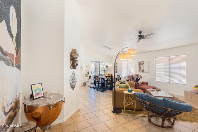 tiled living room featuring ceiling fan and vaulted ceiling