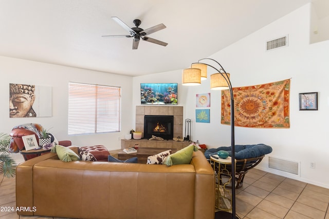 living room with a tile fireplace, tile patterned flooring, ceiling fan, and lofted ceiling