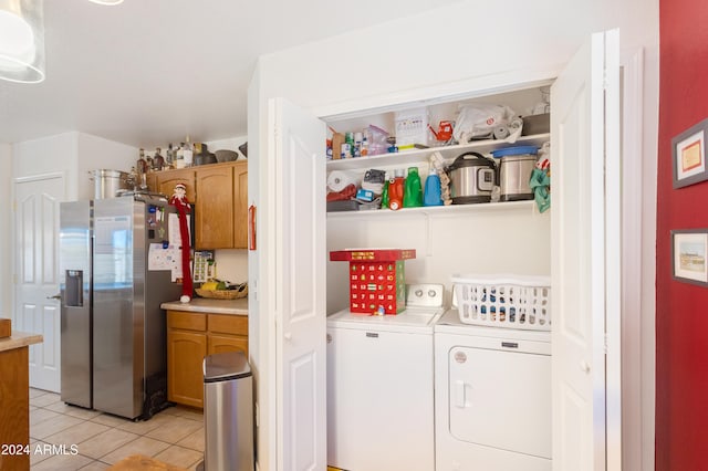 laundry area featuring light tile patterned flooring and independent washer and dryer