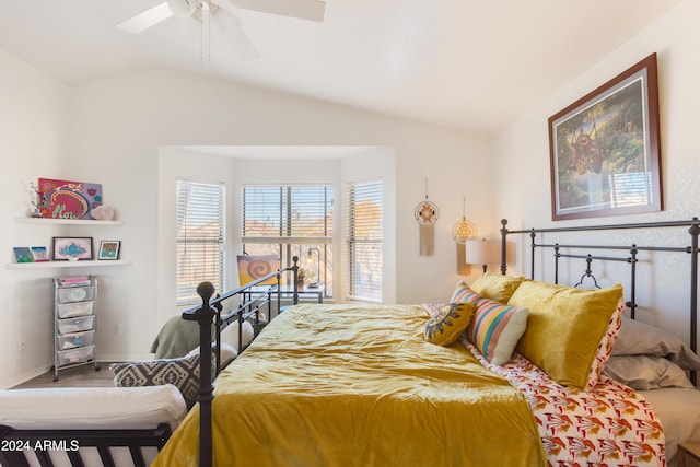 bedroom with ceiling fan, hardwood / wood-style floors, and vaulted ceiling