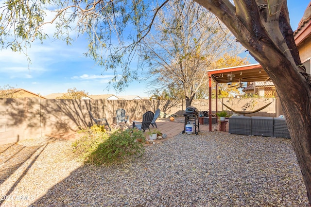 view of yard with ceiling fan and a patio area