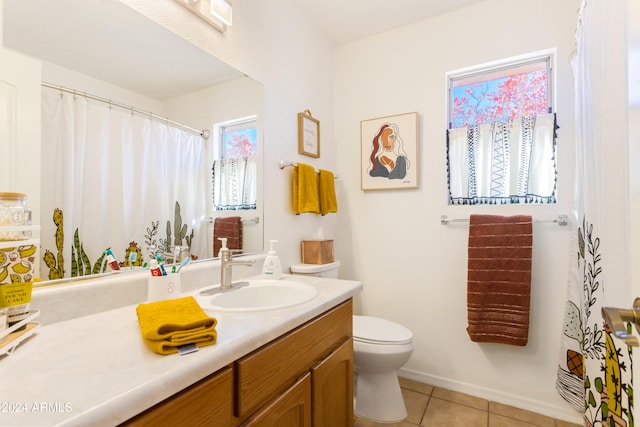 bathroom with tile patterned flooring, vanity, and toilet