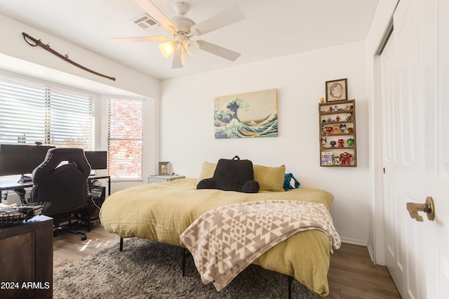 bedroom with a closet, ceiling fan, and hardwood / wood-style floors