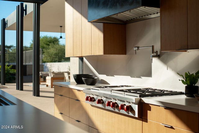 kitchen with light brown cabinets, stainless steel gas cooktop, and custom exhaust hood