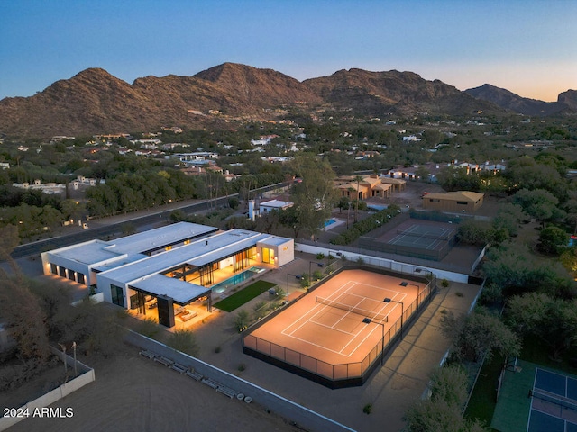 aerial view at dusk featuring a mountain view