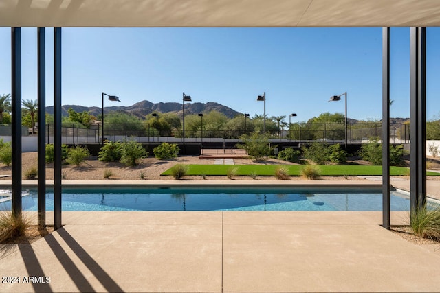 view of pool with a mountain view and a patio