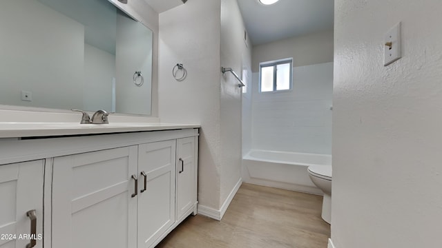 full bathroom with  shower combination, wood-type flooring, toilet, and vanity