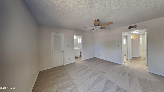 carpeted empty room with a textured ceiling and ceiling fan