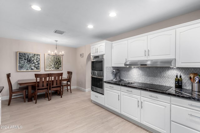 kitchen with white cabinetry, stainless steel double oven, hanging light fixtures, a notable chandelier, and black electric stovetop