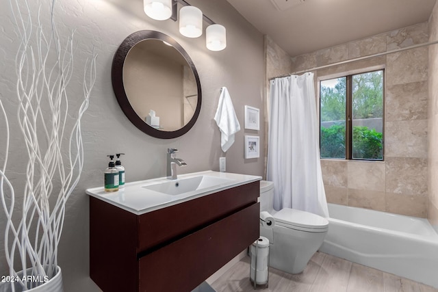 full bathroom with vanity, toilet, and shower / tub combo with curtain