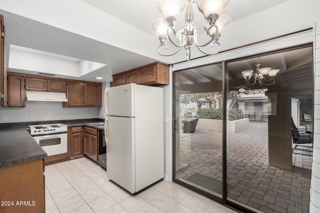 kitchen featuring decorative light fixtures, light tile patterned flooring, white appliances, and an inviting chandelier