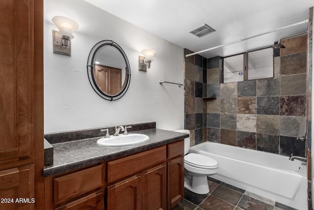 full bathroom featuring vanity, toilet, and tiled shower / bath