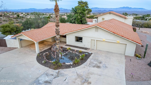 view of front of home with a mountain view and a garage