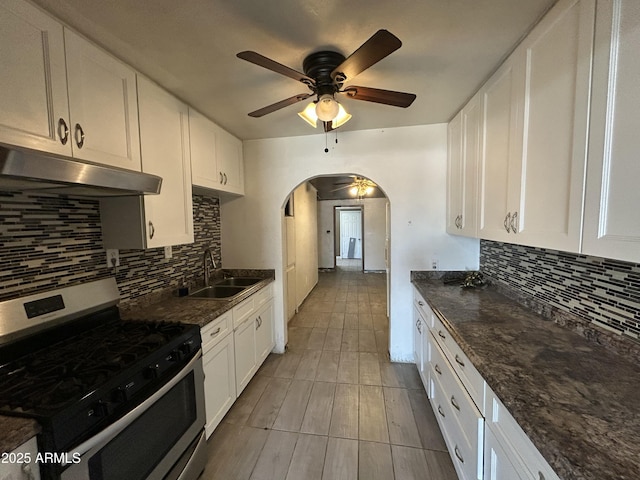 1816 N 38th Dr, Phoenix, AZ 85009 - kitchen featuring stainless steel range with gas cooktop, under cabinet range hood, a sink, arched walkways, and a ceiling fan