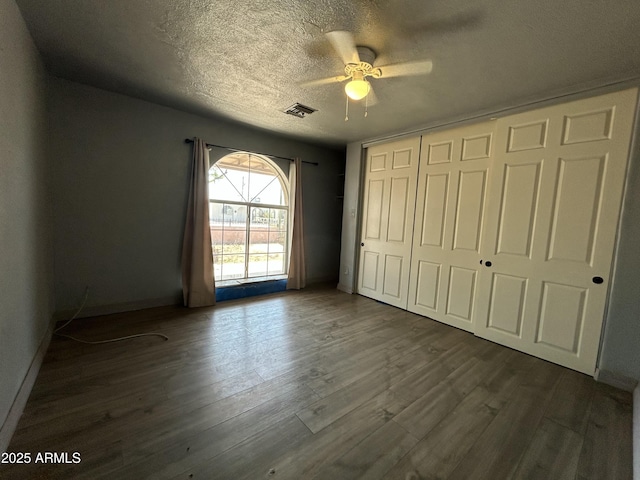 1816 N 38th Dr, Phoenix, AZ 85009 - unfurnished bedroom with a closet, dark wood-type flooring, baseboards, a textured ceiling, and ceiling fan