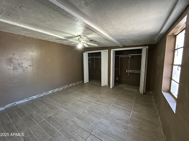 1816 N 38th Dr, Phoenix, AZ 85009 - unfurnished bedroom featuring a textured ceiling, multiple closets, and a ceiling fan