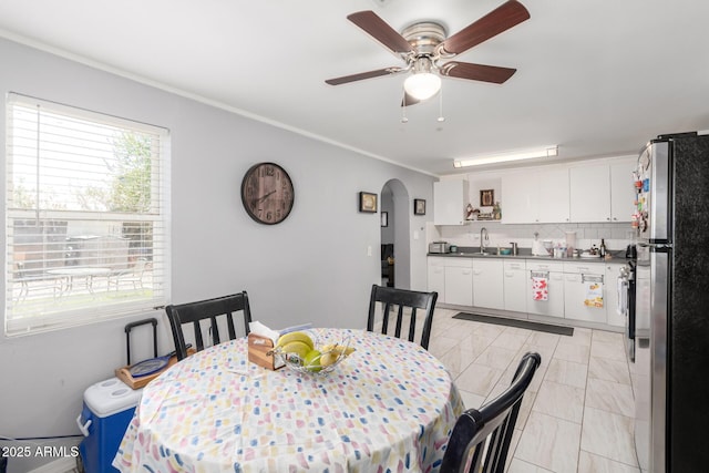 5044 N 18th Ave, Phoenix, AZ 85015 - dining space featuring arched walkways, a ceiling fan, and ornamental molding