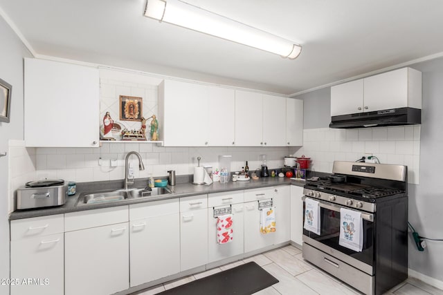5044 N 18th Ave, Phoenix, AZ 85015 - kitchen featuring stainless steel gas range, under cabinet range hood, decorative backsplash, and dark countertops
