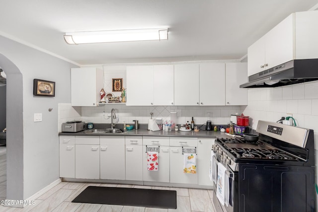 5044 N 18th Ave, Phoenix, AZ 85015 - kitchen featuring stainless steel gas range oven, under cabinet range hood, dark countertops, and backsplash