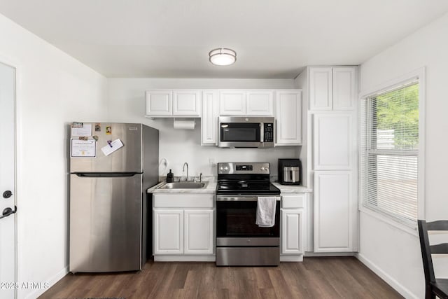 5044 N 18th Ave, Phoenix, AZ 85015 - kitchen featuring stainless steel appliances, dark wood-type flooring, white cabinets, and light countertops