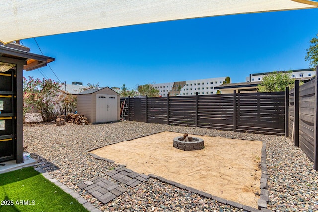 5044 N 18th Ave, Phoenix, AZ 85015 - fenced backyard featuring a storage shed, a fire pit, and a patio